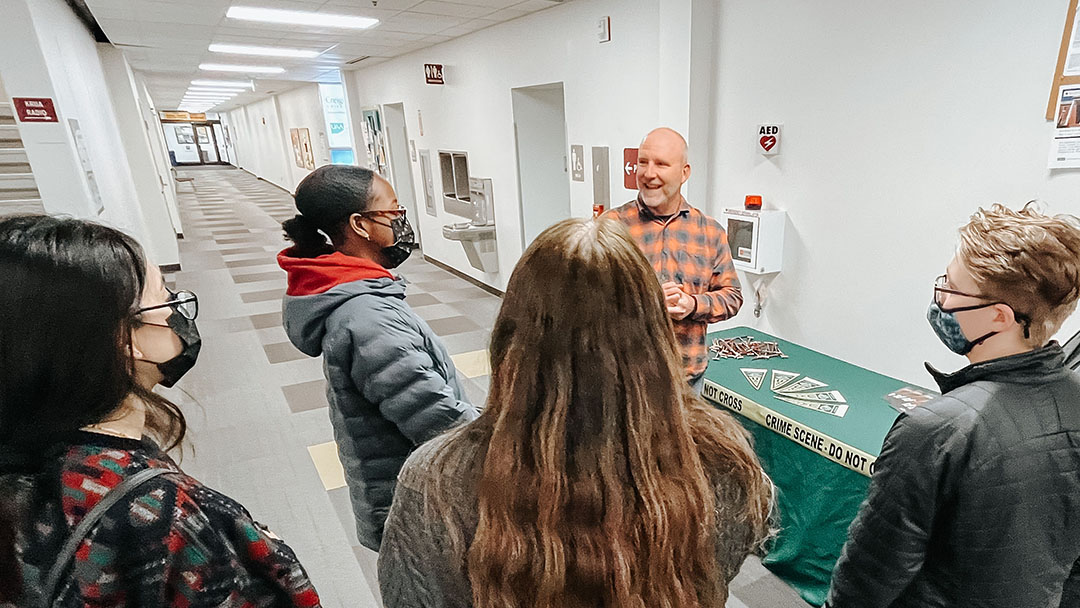 Justice Center Director Dr. Brad Myrstol speaks to high school student about the programs offered at the Justice Center