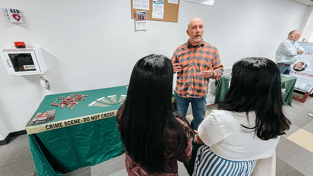 Justice Center Director Dr. Brad Myrstol speaks to high school students about the programs offered at the Justice Center