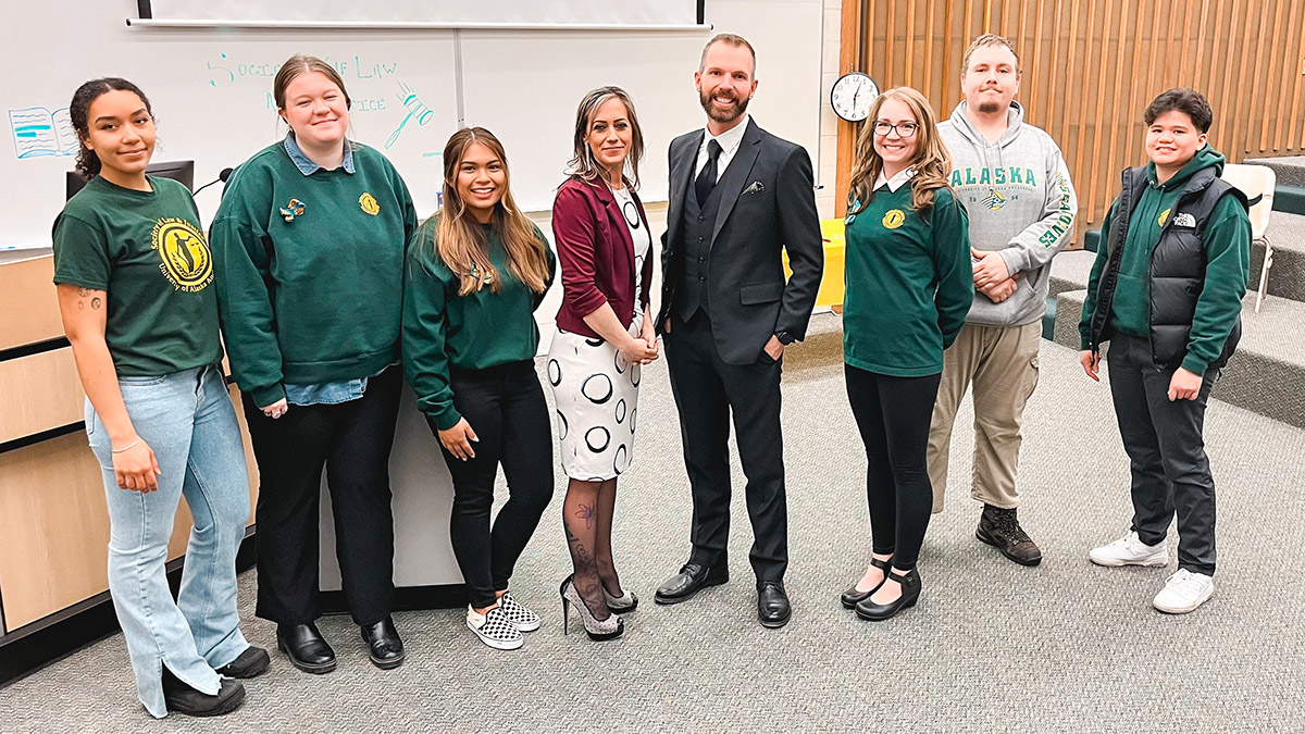 Society of Law & Justice members take a photo with guest speakers Blake F. Quackenbush and Whitney Rowe