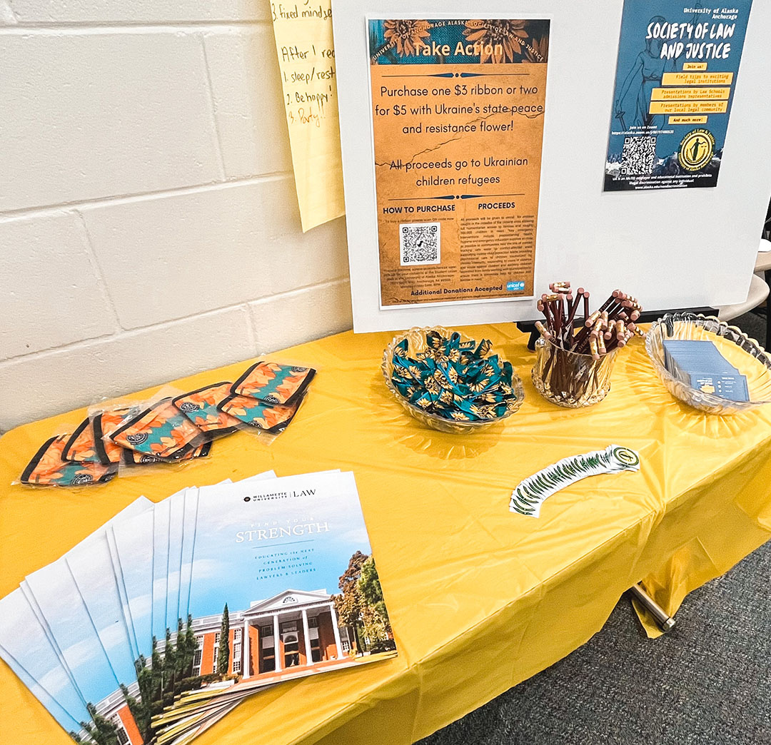 A donation drive and various swag items are displayed at the Social of Law & Justice Social 