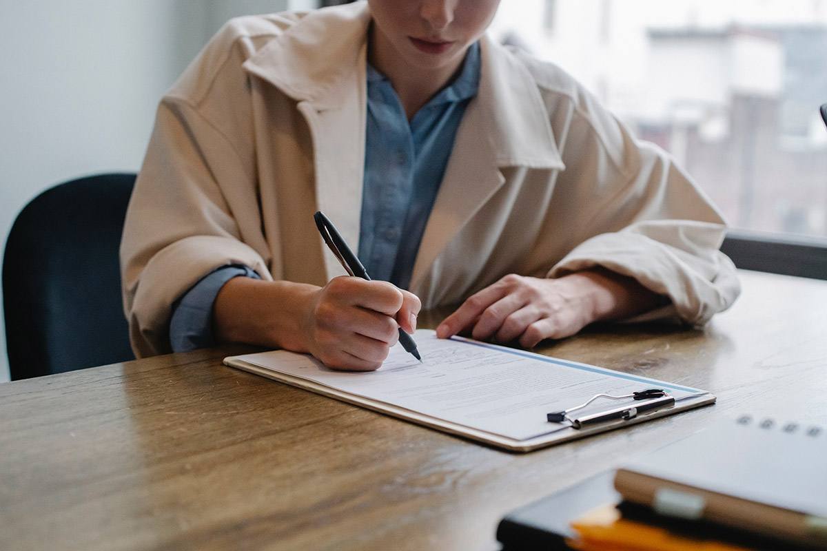 A woman signing a document