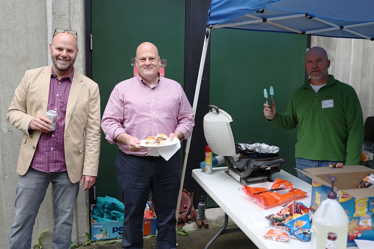 Assistant professor Rob Henderson, College of Health Associate Dean Andre Rosay, and professor Brad Myrstol welcome students back to campus during the Return to Campus BBQ event the Justice Center hosted for its returning students on Sept. 8, 2022, at the Professional Studies Building of the University of Alaska Anchorage. (Photo by Ahliil Saitanan/College of Health Dean's Office)