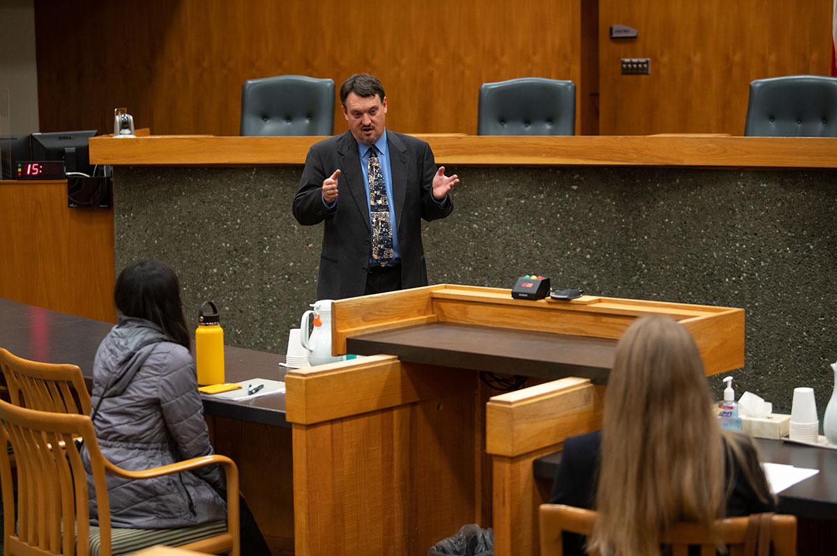 Ryan Fortson briefing LEGL A487 student before they present their oral arguments