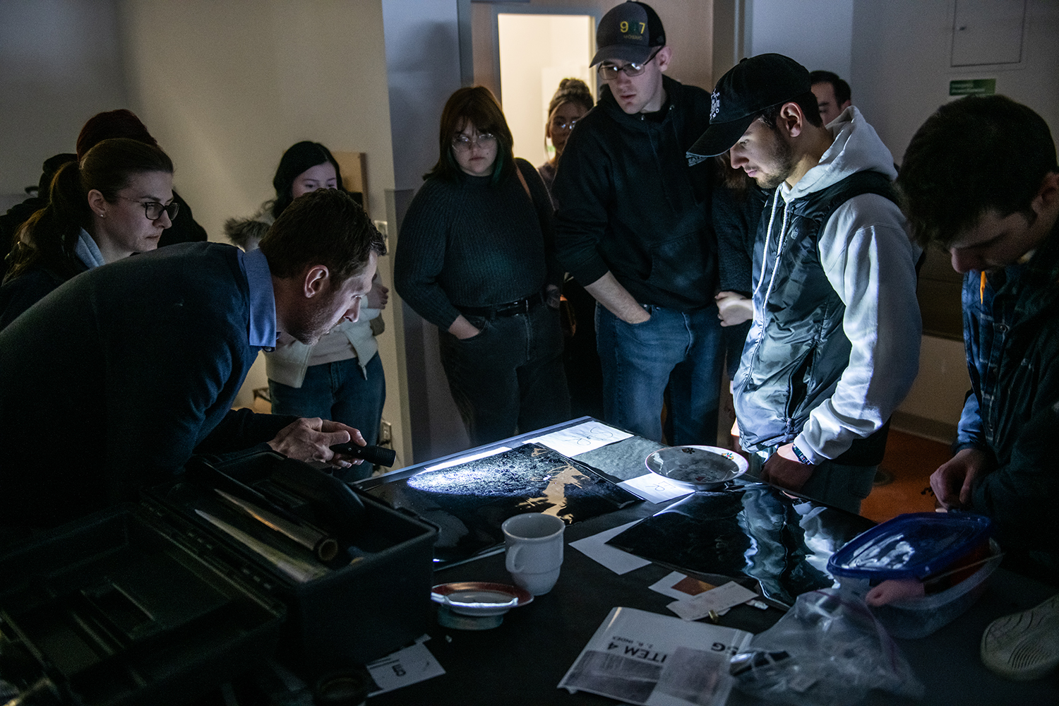 David Kanaris examines footprint with students 