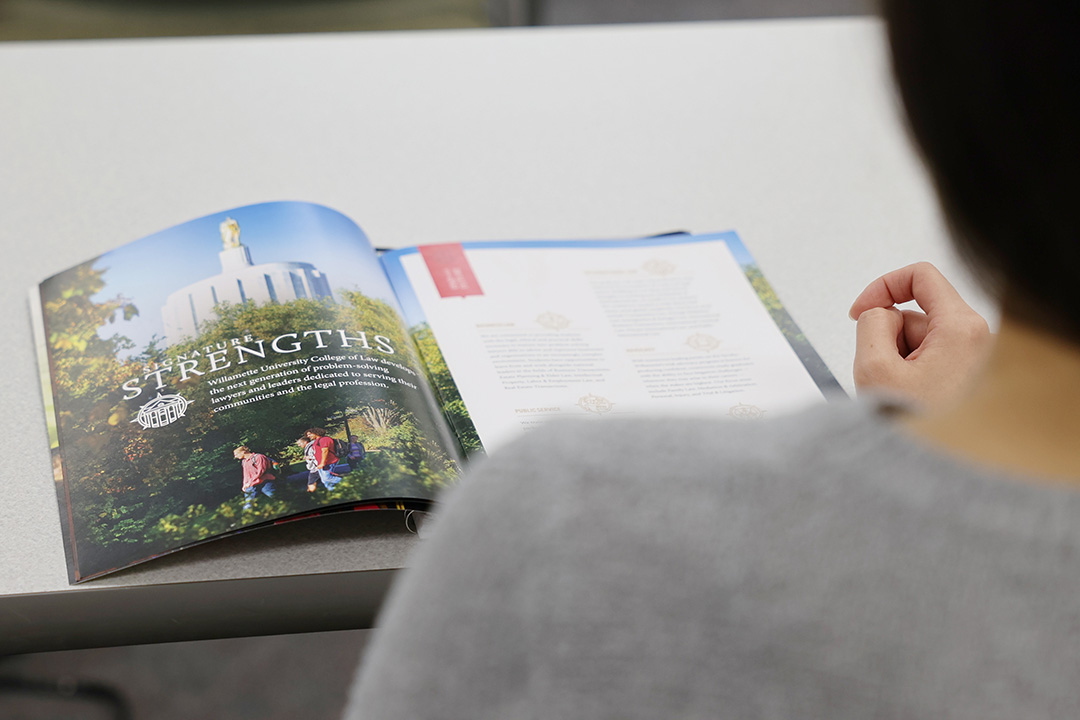 person reading pamphlet on table 