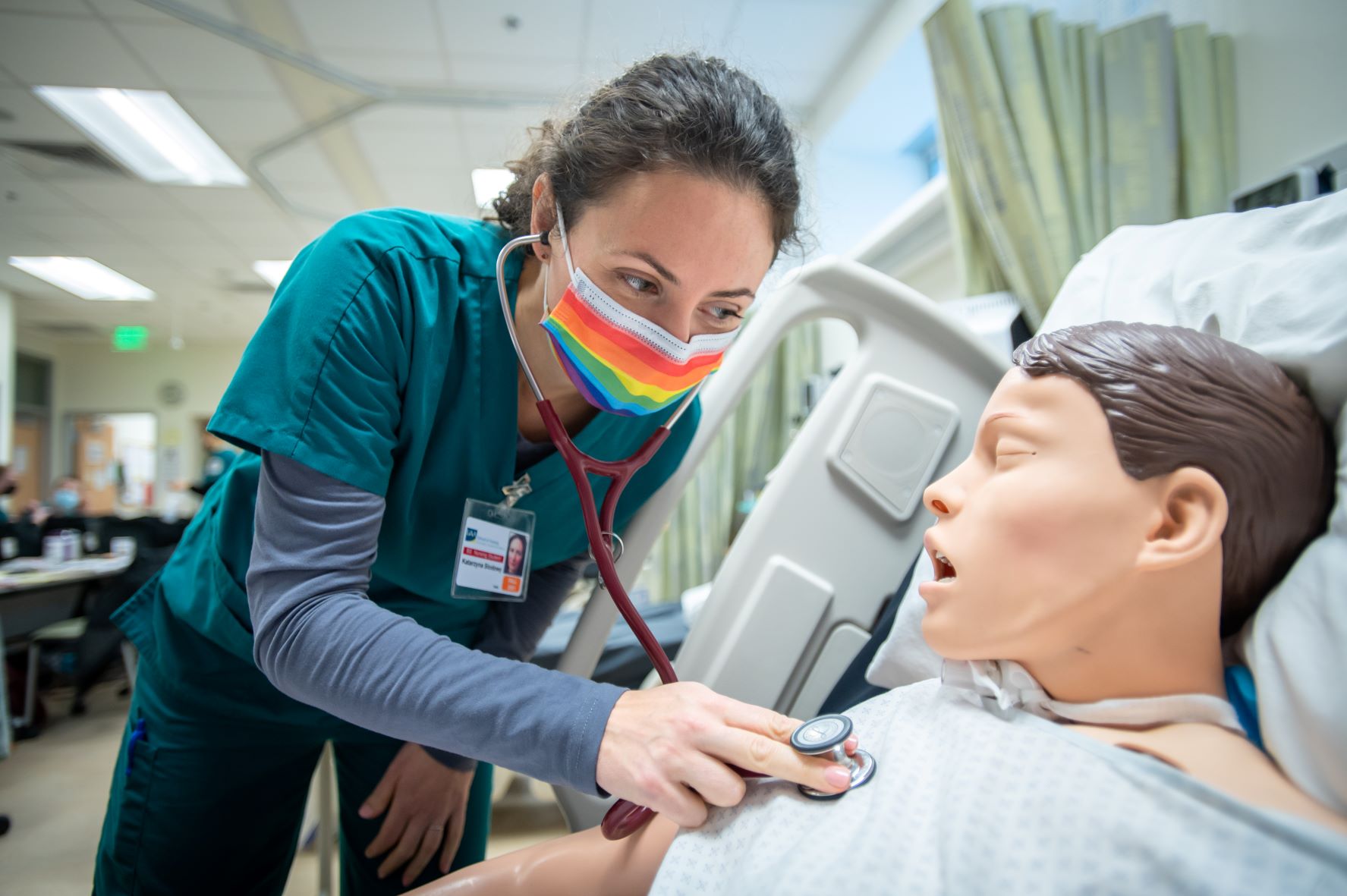 Undergraduate nursing student practicing on mannequin