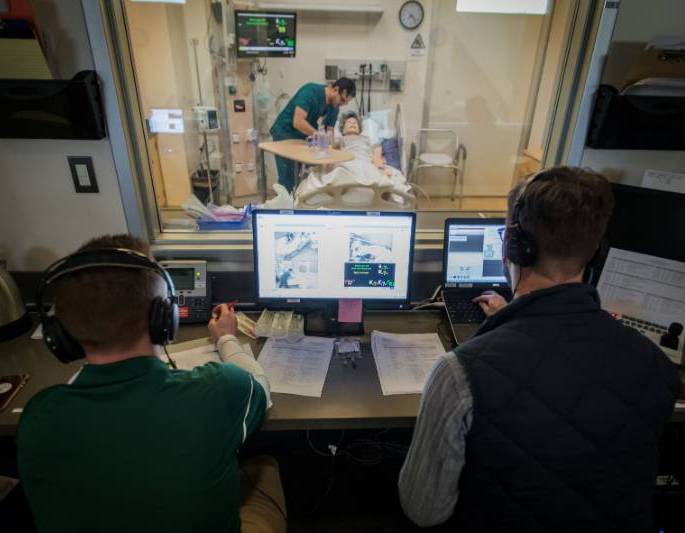 Nursing student checking manikin in simulation center