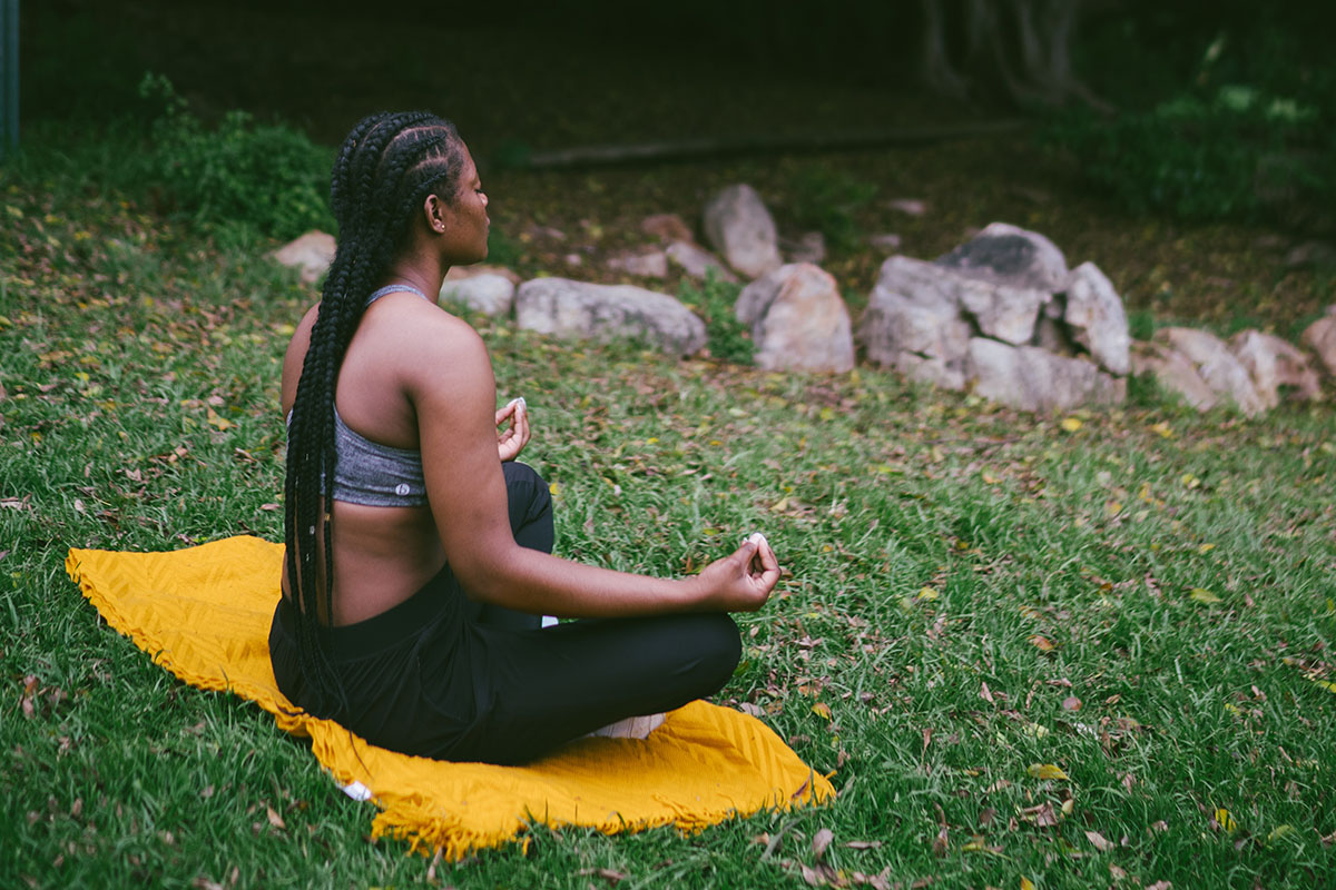 A woman meditates outdoors