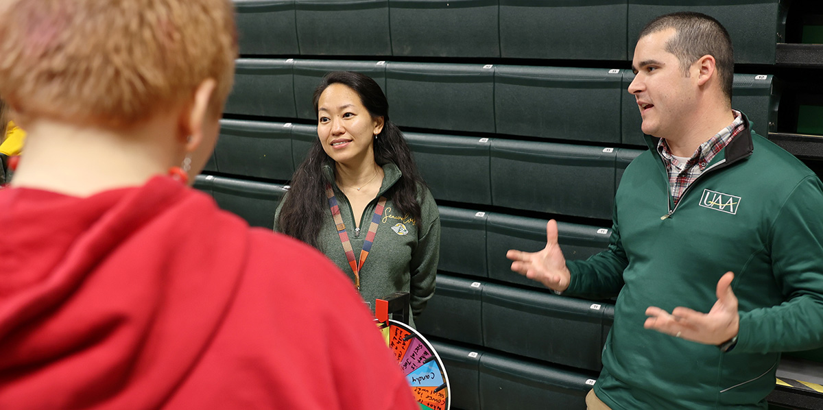 School of Social Work assistant professors Matthew Cuellar and Rei Shimizu speaking with students during UAA Preview Day on Sept. 30 at the Alaska Airlines Center