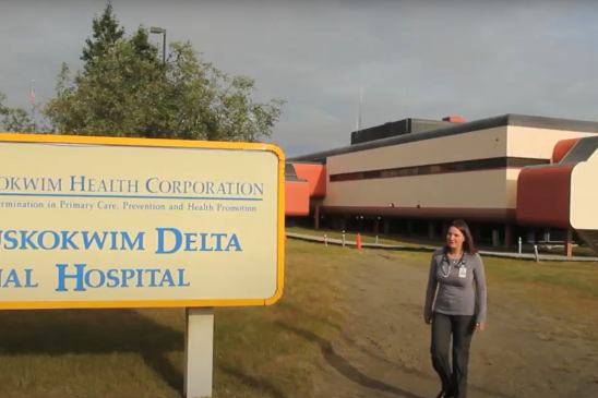 doctor walking by hospital sign in Bethel, AK