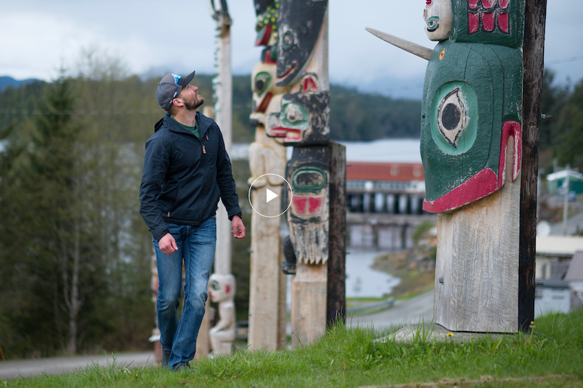 Stephen Ellison walking among totem poles