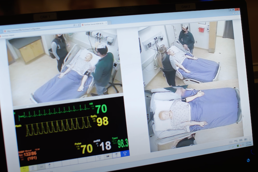 camera feed of students working in a simulation lab