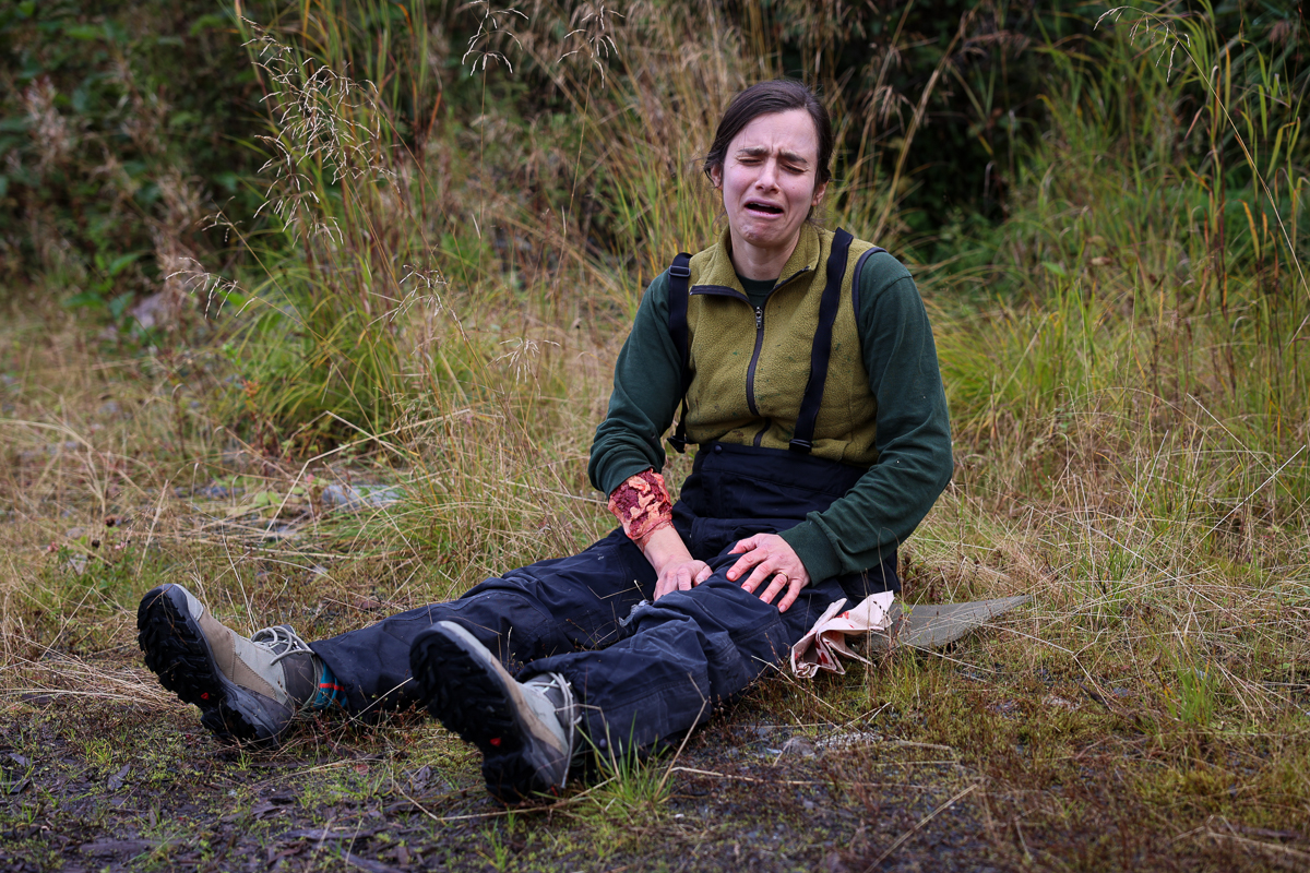 an injurred woman sitting on the ground