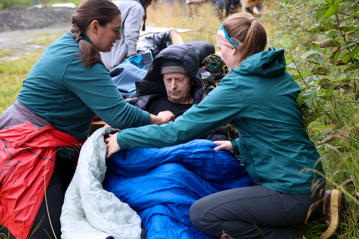 two medical students care for a patient outdoors