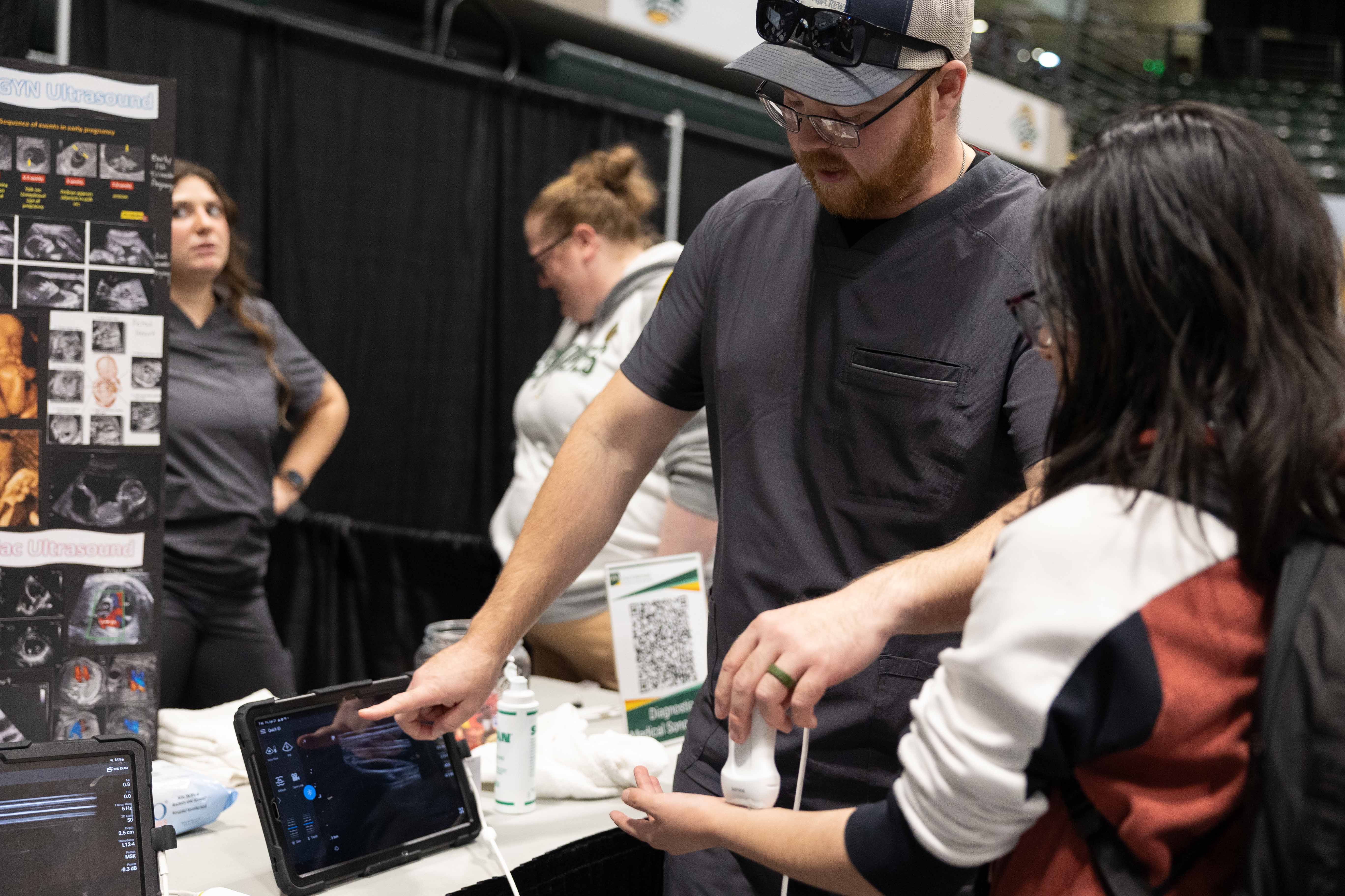 Ryan Benedict using ultrasound on students arm