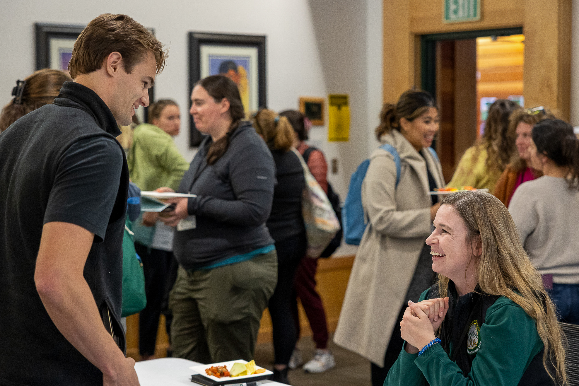 Smiling participants and host at a registration table