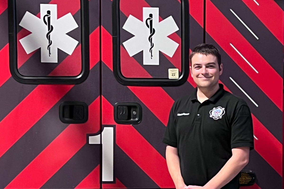 A student in front of an ambulance