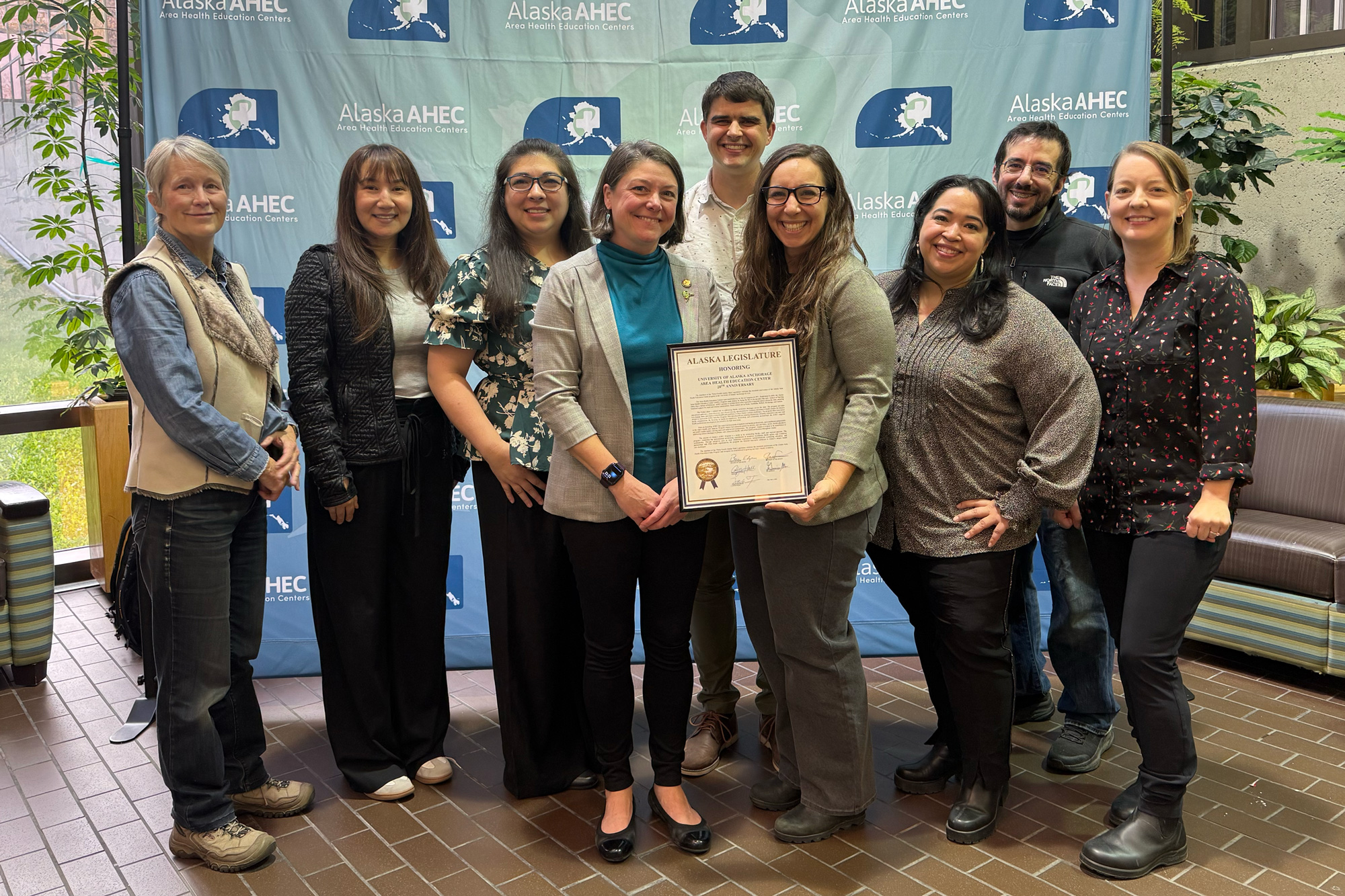 The Alaska Area Health Education Center (AHEC) team gathered to celebrate receiving a Legislative Citation from the Alaska Legislature, honoring 20 years of dedicated work. The recognition celebrates AHEC’s crucial role in strengthening the state’s health care workforce and promoting health equity across Alaska. (Photo by Kevin Bennett, UAA Alaska Center for Rural Health & Health Workforce)