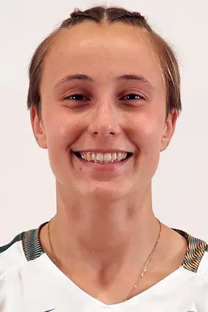 Lee Ivakina is wearing a white jersey and smiling at the camera.