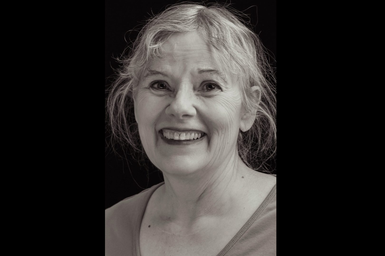 A black and white portrait depicts Dr. Jean Snyder smiling. 