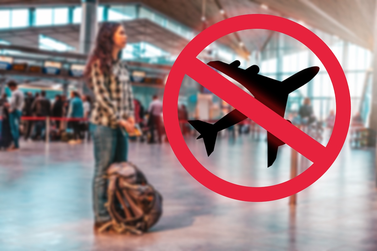 Person in airport with luggage behind an image of an airplane crossed out