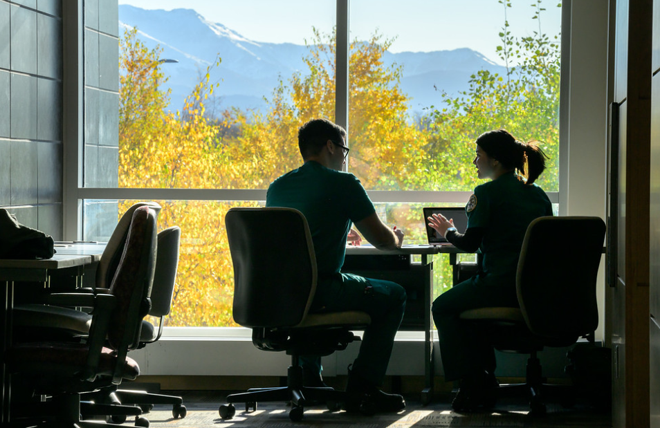 students talking by window
