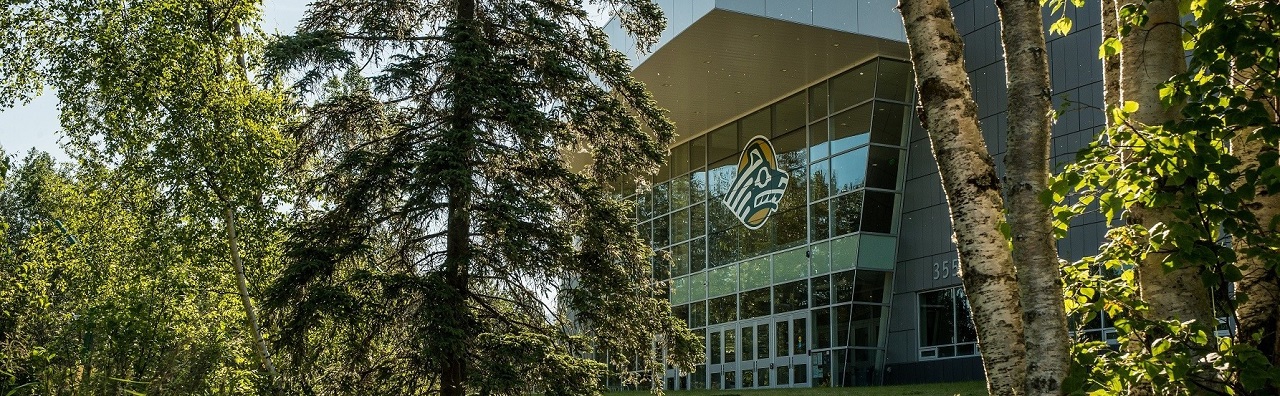 Seawolf Logo on a building surrounded by trees on a sunny day