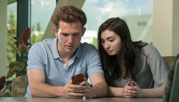 Two students look at a phone screen