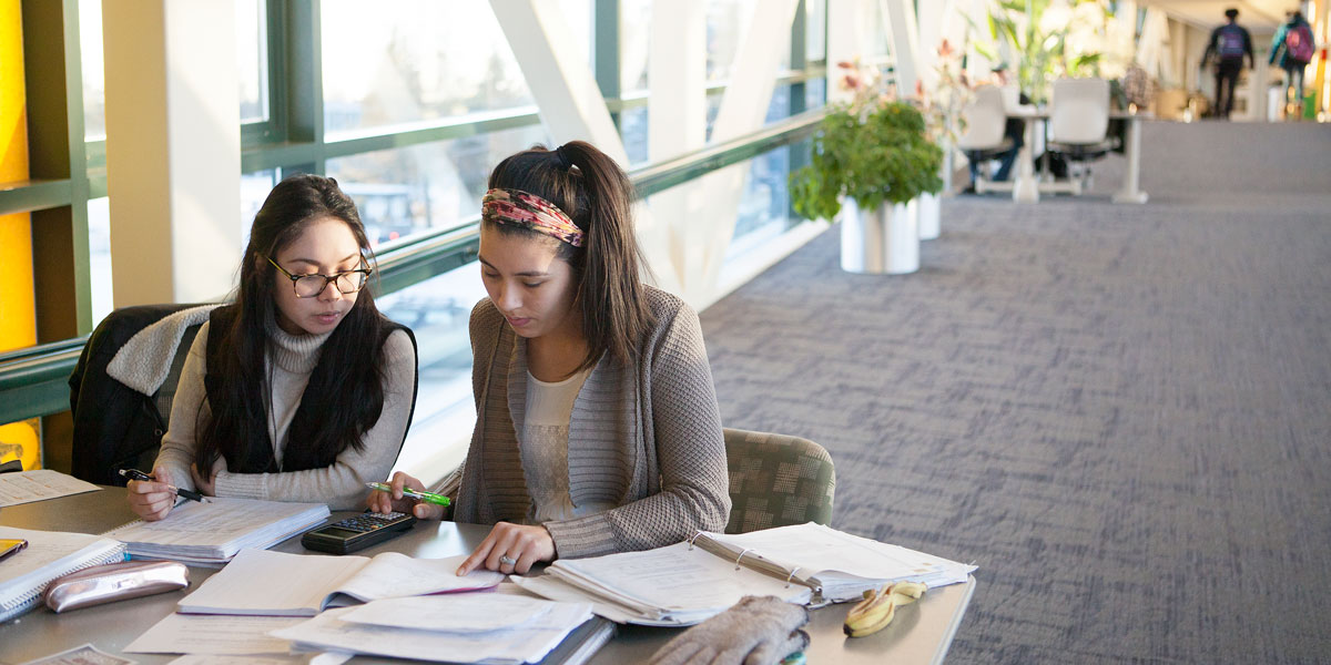 Students studying in a UAA building