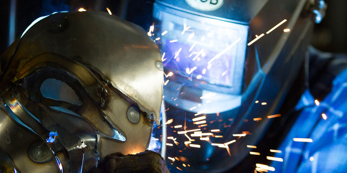 A welding student working on a mask