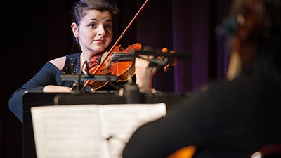 A student plays a violin