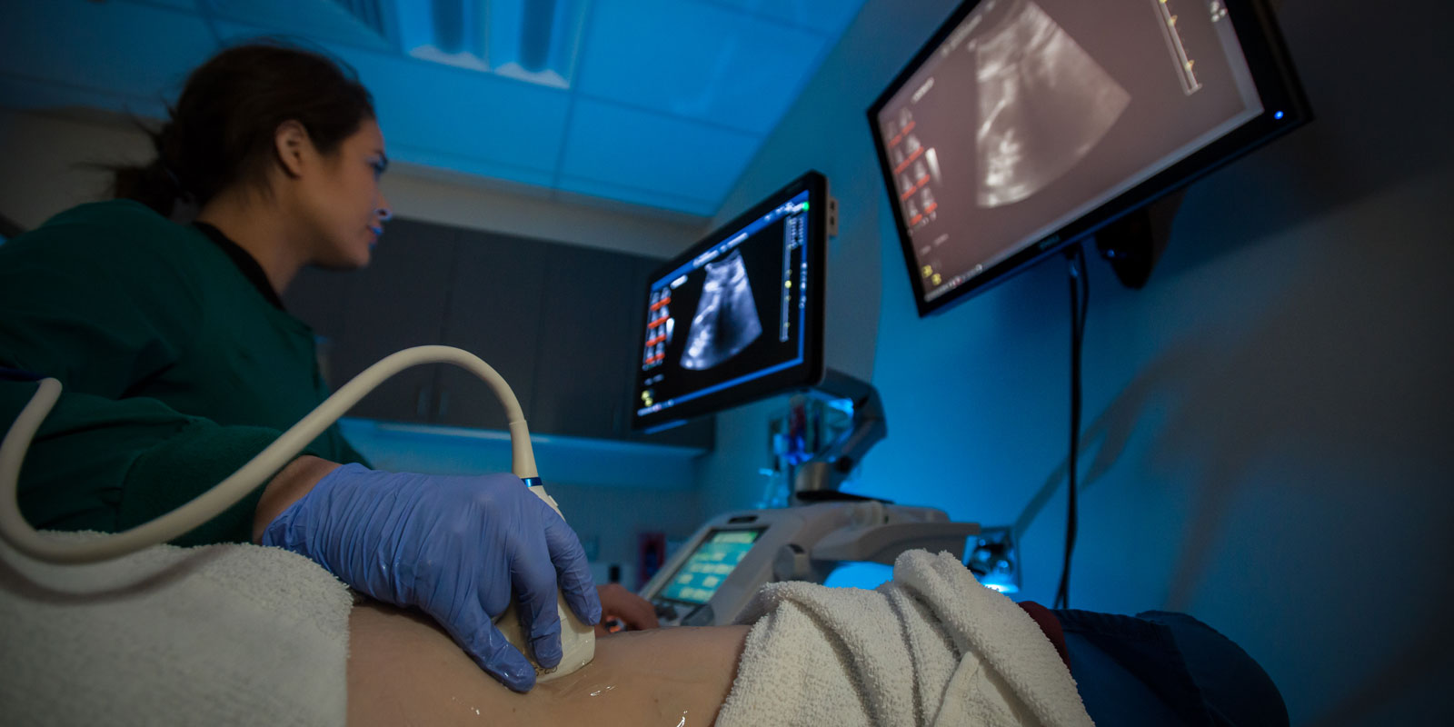 A student technician using an ultrasound