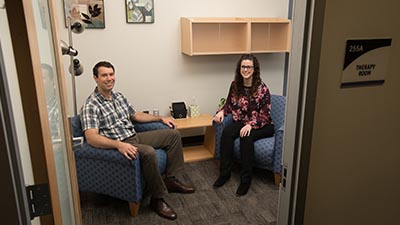 Two employees sit in the psychological services center