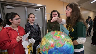 Students looking at a globe