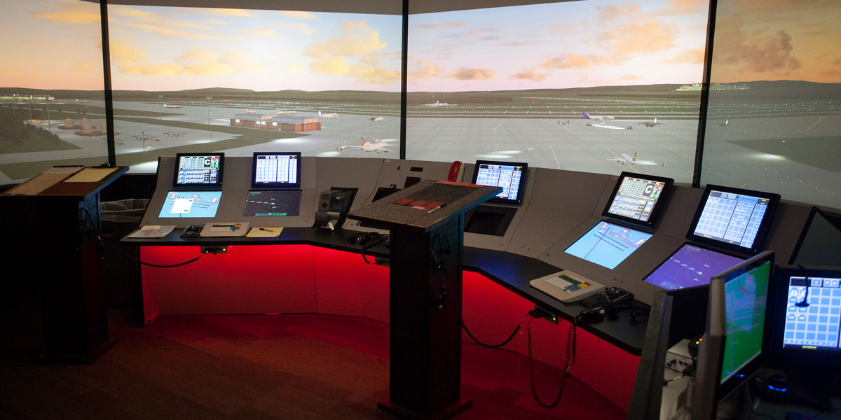 An assortment of air traffic control stations in front a a simulation