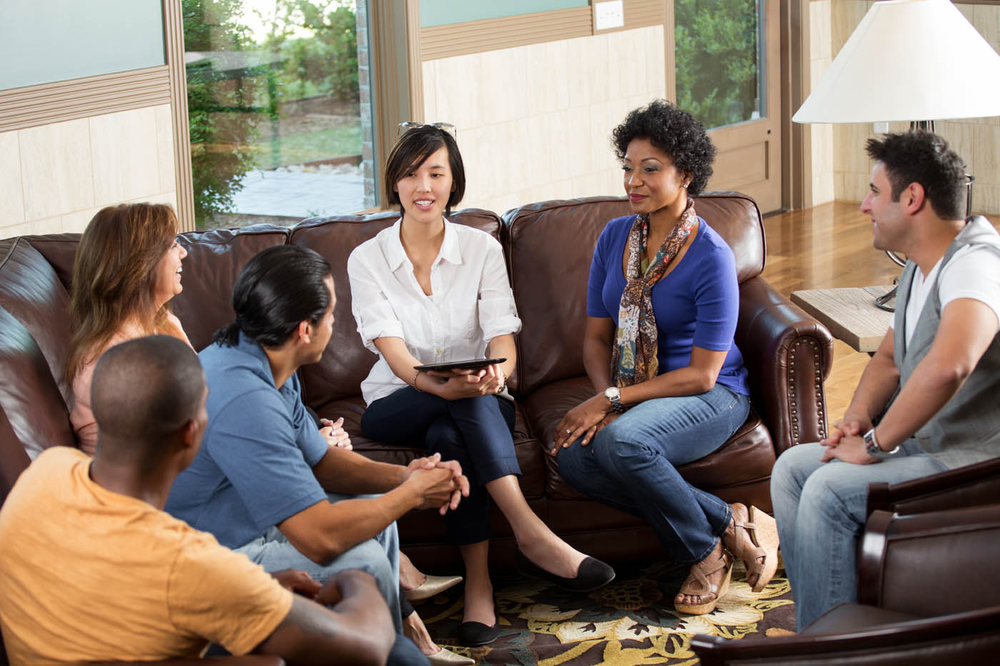 A group of adults sits in discussion