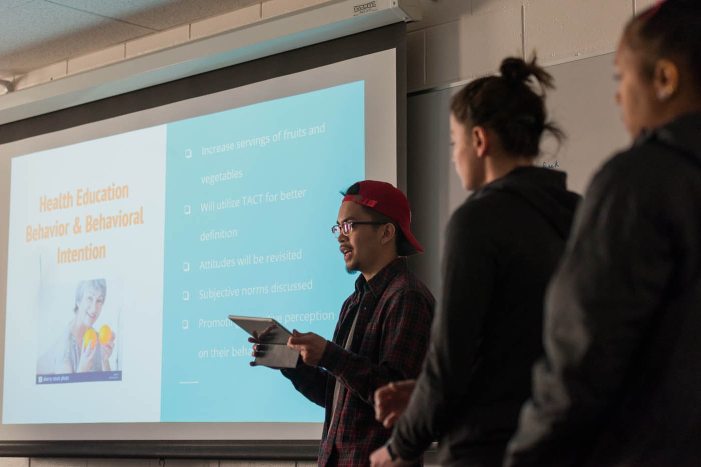 A student gives a presentation in front of class