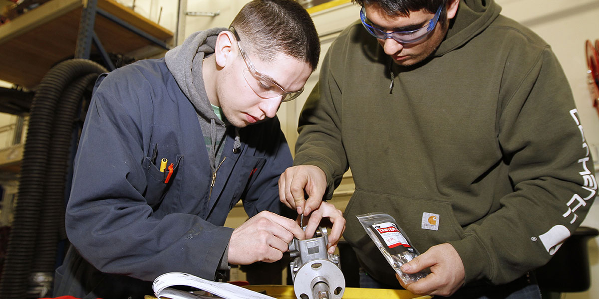 Students working on a small engine