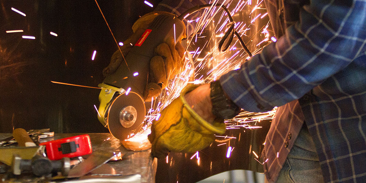 A student using an angle grinder