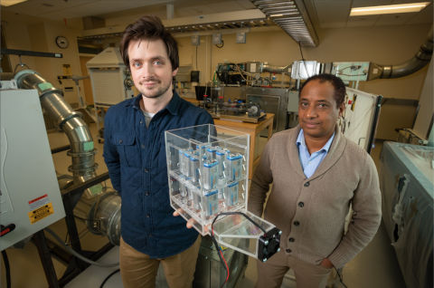 Martin Henke and Dr. Getu Hailu posing with battery cooling system