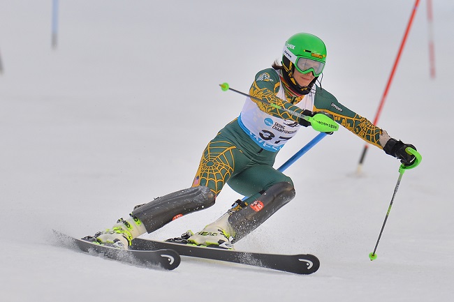 UAA athlete skiing downhill through flags