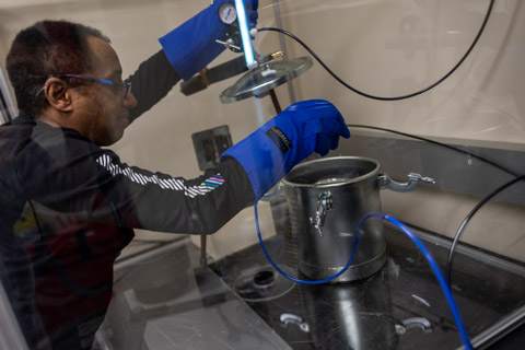 Engineering professor Getu Hailu works with liquid nitrogen and various metals