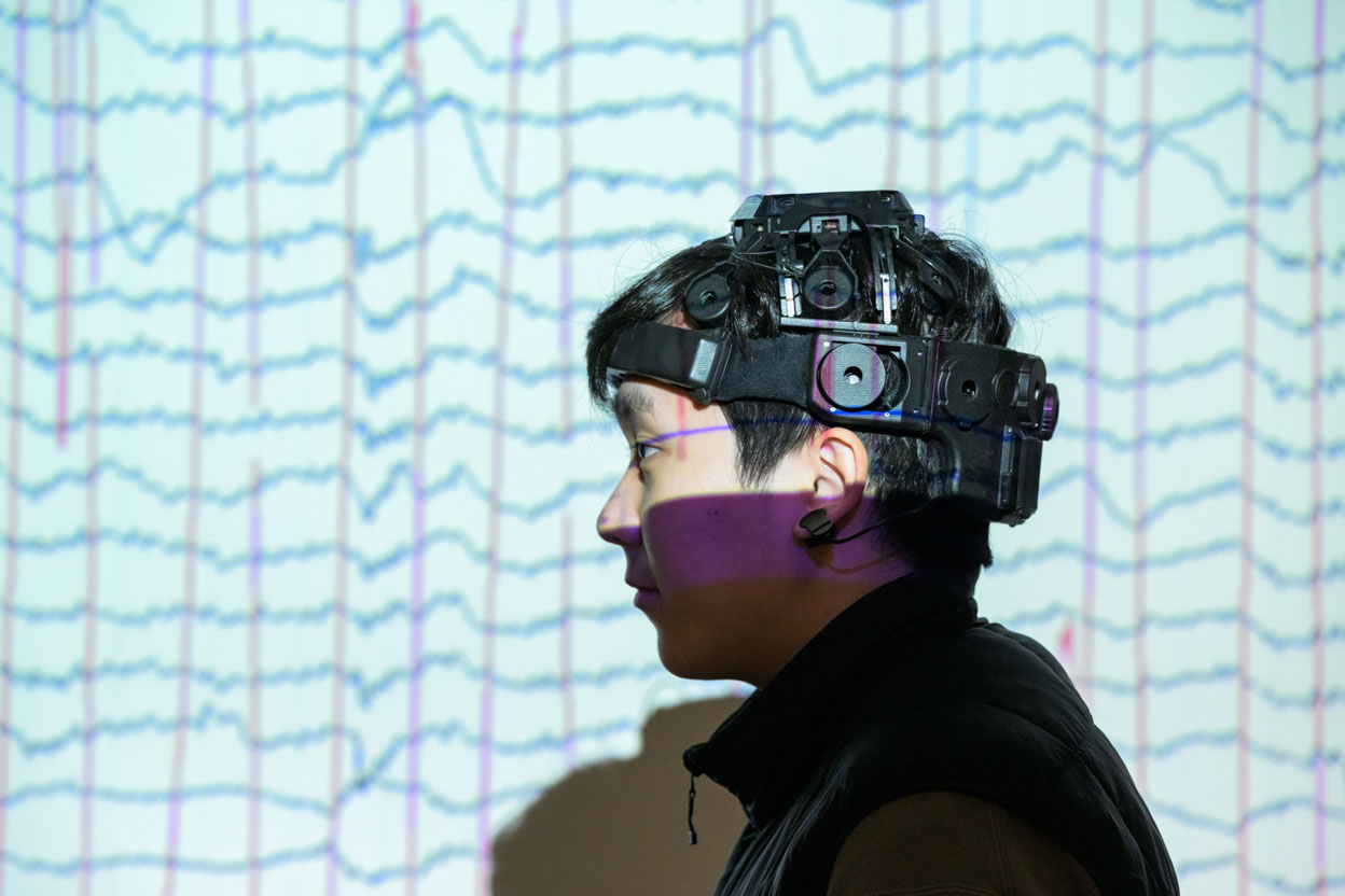 Man wearing brain activity monitoring system on head