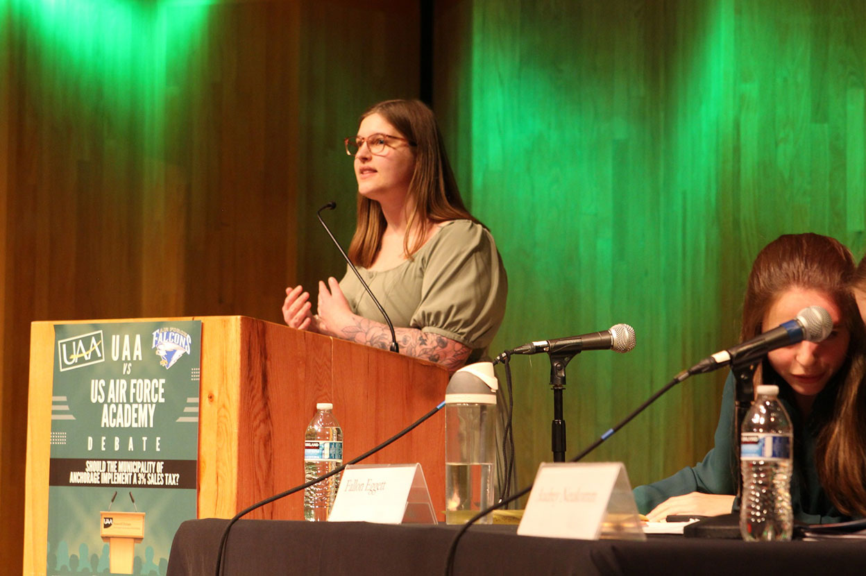 Woman debating behind lectern