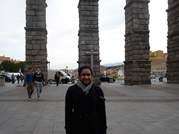 Meneka Thiru in front of a Roman aqueduct in Segovia, Spain