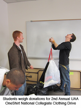 Students weigh donations for the OneShirt Clothing Drive