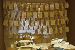  Installation view of "The Censorship of Memory," video projection, pages ripped out of encyclopedias coated with clay slip, 2012.