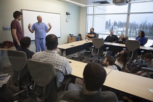 Dr. Steve Tower, an Anchorage orthopedic surgeon and former WWAMI student, gives information about shoulder exams to an audience that includes WWAMI students.