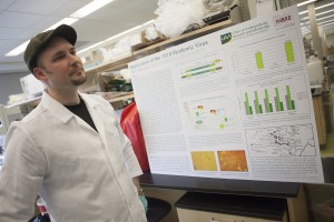 Robert stands next to his research poster for the 2014 Undergraduate Research and Discovery Symposium. Photo by Philip Hall/University of Alaska Anchorage.
