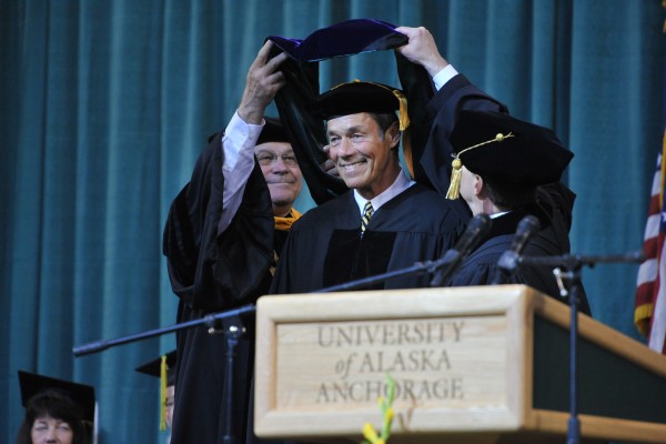 Former Alaska governor Tony Knowles receives an academic hood with his honorary degree at the 2012 commencement.